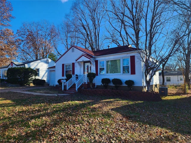 bungalow-style house with a garage, driveway, and a front lawn