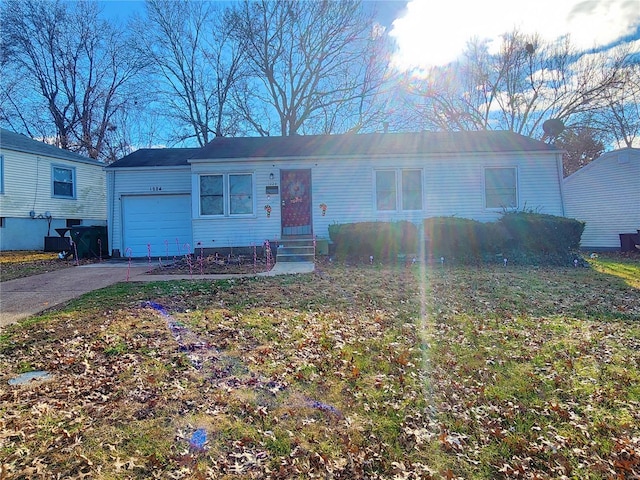 single story home with entry steps, driveway, and an attached garage