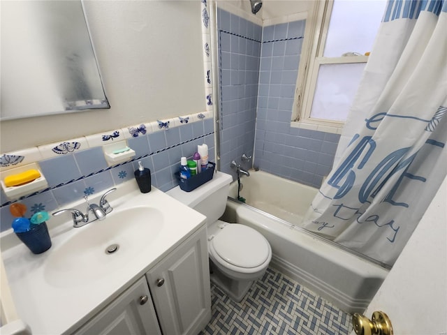 full bath featuring toilet, tile walls, vanity, and shower / bath combo with shower curtain