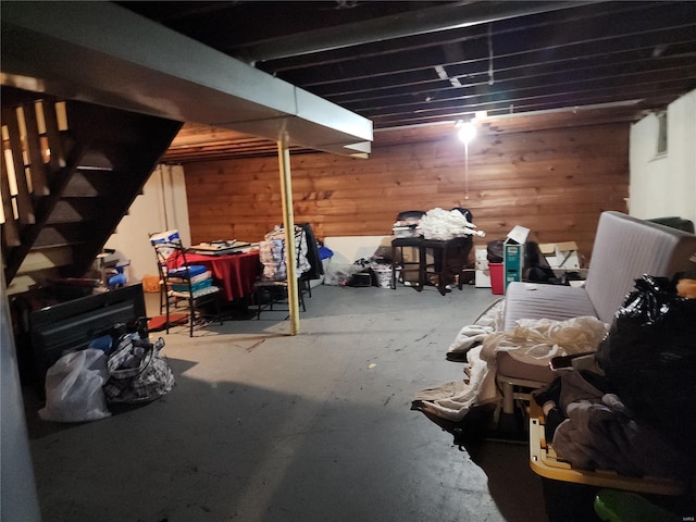 finished basement featuring wooden walls