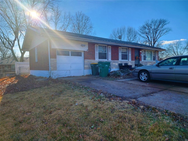 ranch-style home featuring driveway, brick siding, an attached garage, fence, and a front yard