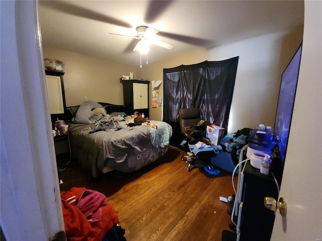 bedroom featuring ceiling fan and wood finished floors