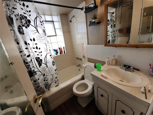 full bathroom with shower / tub combo with curtain, vanity, and toilet