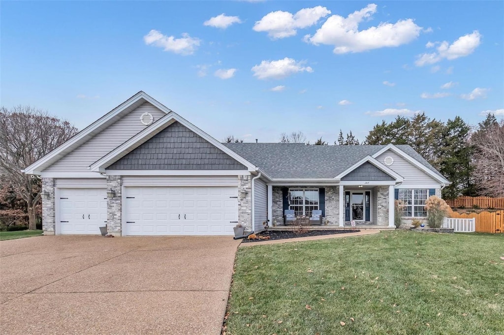 view of front of property with concrete driveway, an attached garage, fence, central air condition unit, and a front yard