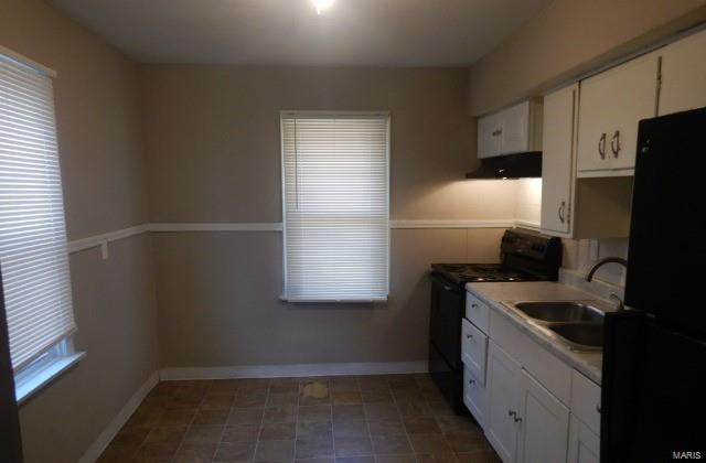 kitchen with white cabinetry, sink, black appliances, and range hood