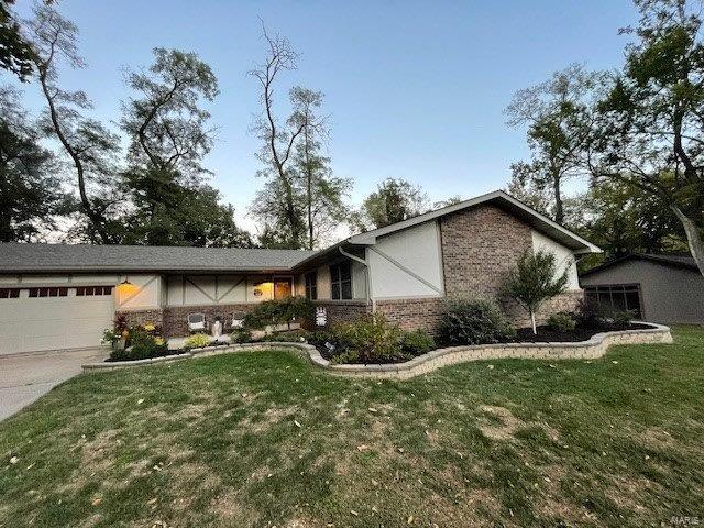 ranch-style house featuring a front yard and a garage