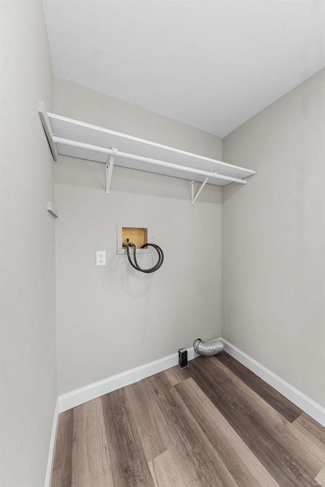 clothes washing area featuring hardwood / wood-style flooring and washer hookup