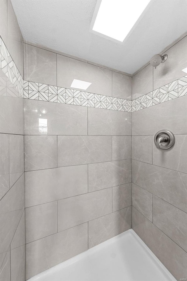 bathroom with a tile shower