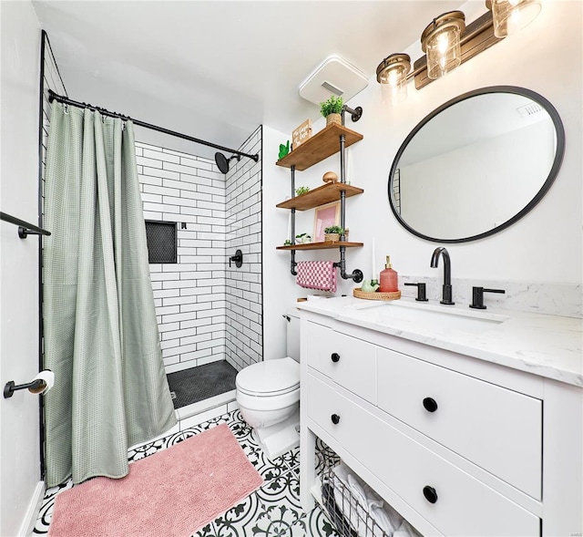 bathroom featuring curtained shower, tile patterned flooring, vanity, and toilet