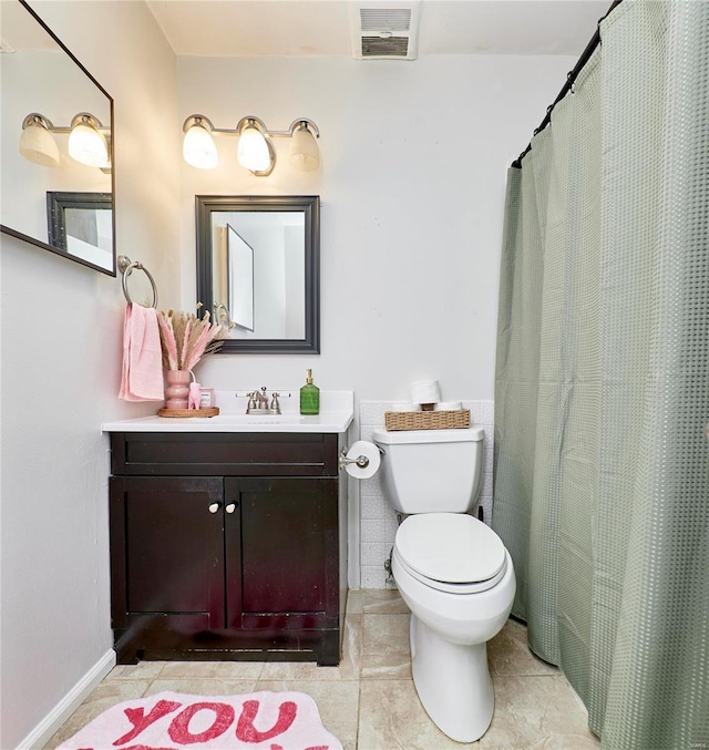 bathroom featuring tile patterned floors, vanity, and toilet