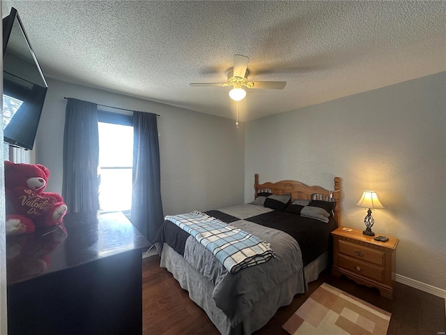 bedroom featuring a textured ceiling, ceiling fan, and dark hardwood / wood-style floors