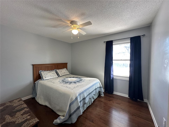 bedroom featuring dark hardwood / wood-style flooring, a textured ceiling, and ceiling fan