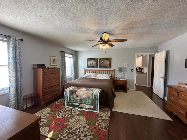 bedroom with a textured ceiling, ceiling fan, and dark hardwood / wood-style floors