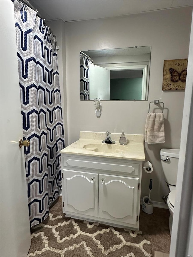 bathroom with toilet and vanity