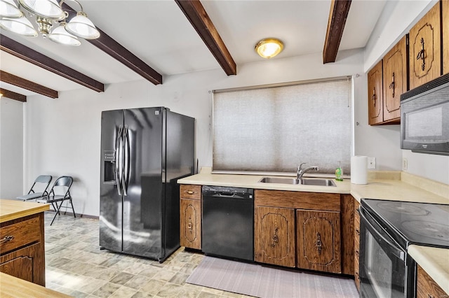 kitchen with black appliances, a notable chandelier, beam ceiling, and sink