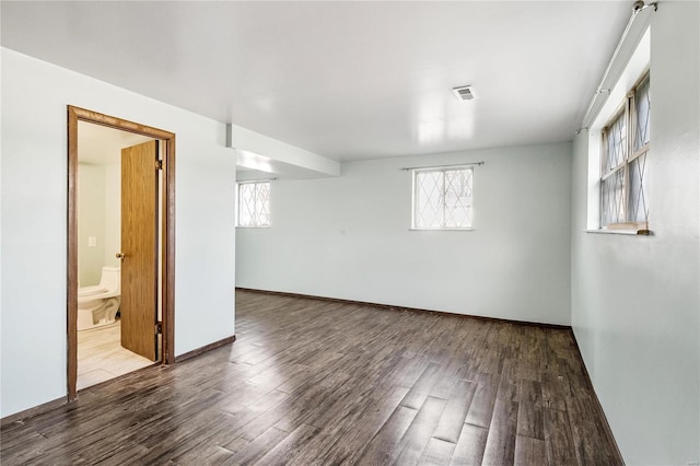 spare room with wood-type flooring