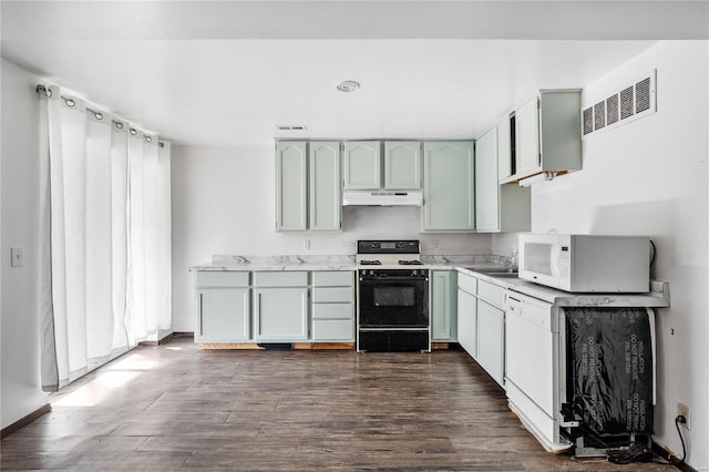 kitchen with sink, dark hardwood / wood-style floors, and white appliances