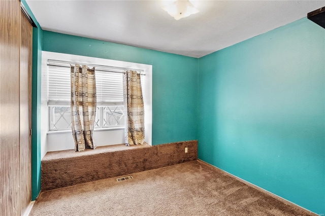 unfurnished room with carpet floors