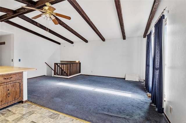 unfurnished living room with ceiling fan, light colored carpet, and lofted ceiling with beams