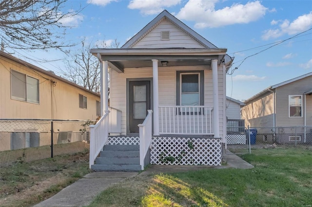 bungalow featuring a front lawn and a porch