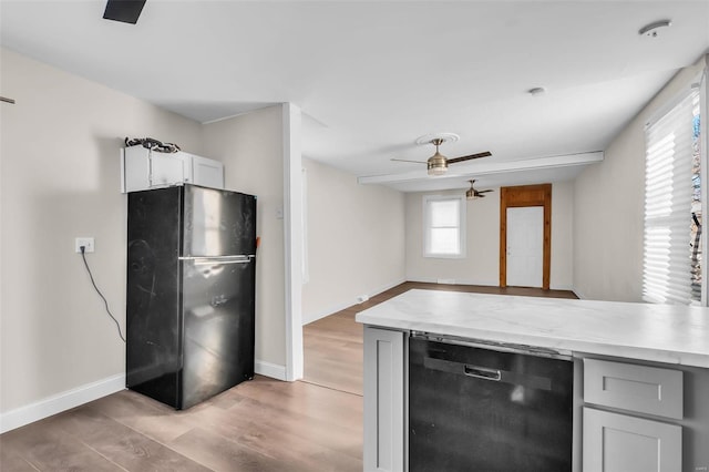 kitchen with ceiling fan, black appliances, and light wood-type flooring