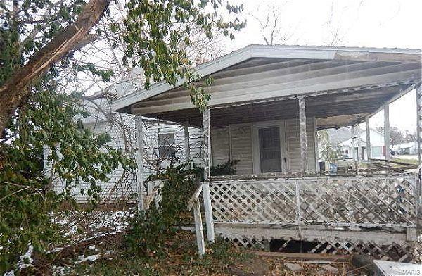 view of side of property featuring a porch