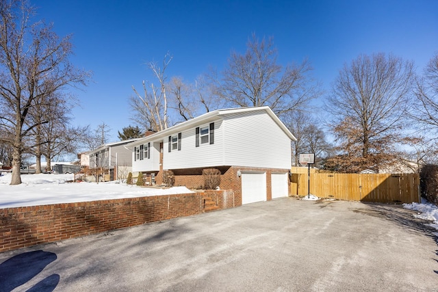 view of snow covered exterior with a garage