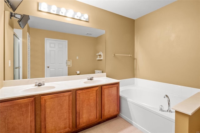 bathroom featuring vanity and a bath