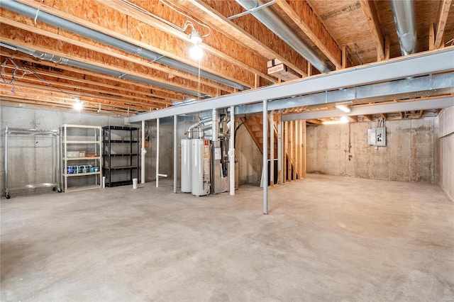 basement featuring electric panel and water heater