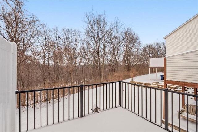 view of snow covered back of property