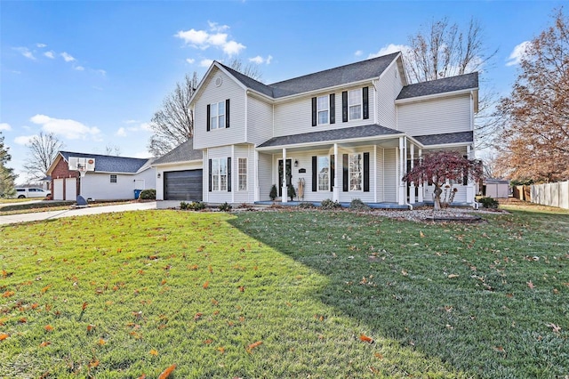 view of front facade with covered porch, a garage, and a front lawn