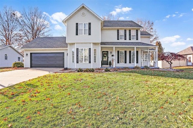 view of front of home featuring a front yard, a porch, and a garage