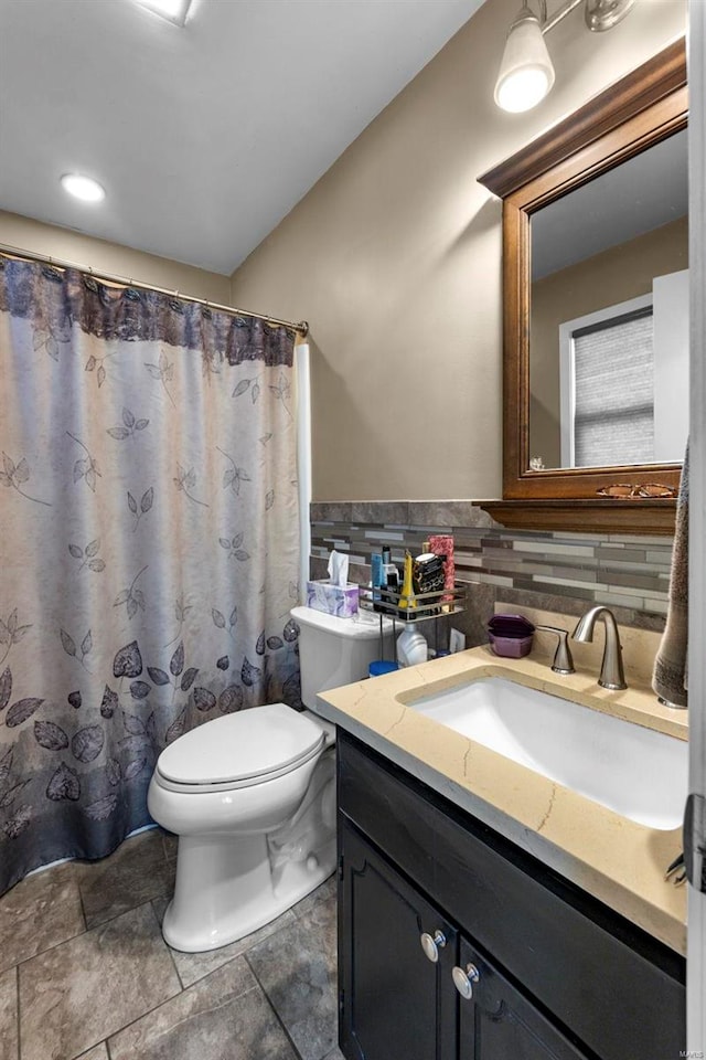 bathroom with tile patterned floors, decorative backsplash, vanity, and toilet