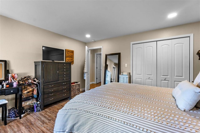 bedroom featuring dark hardwood / wood-style flooring and a closet