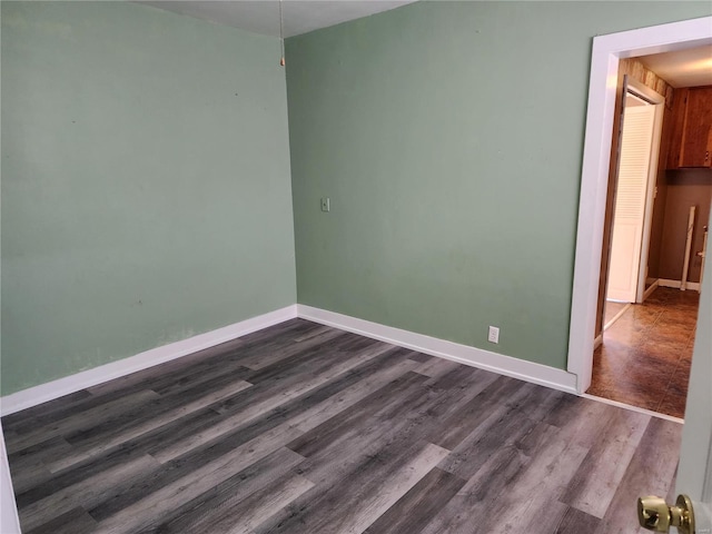 spare room with dark hardwood / wood-style flooring