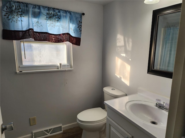 bathroom featuring hardwood / wood-style flooring, vanity, and toilet