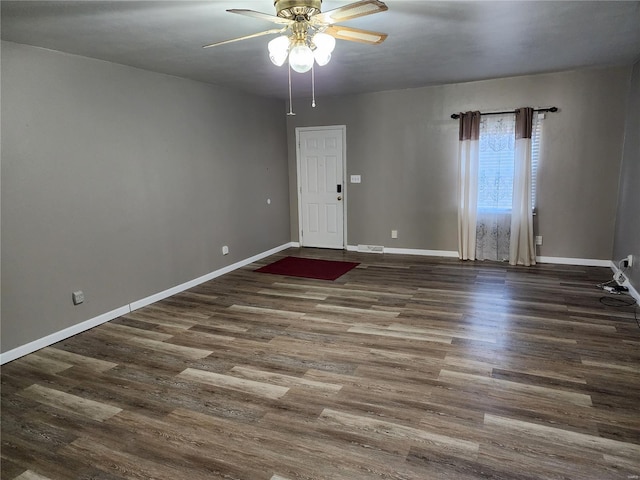 spare room featuring dark hardwood / wood-style floors and ceiling fan