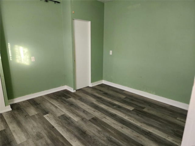 spare room featuring dark wood-type flooring