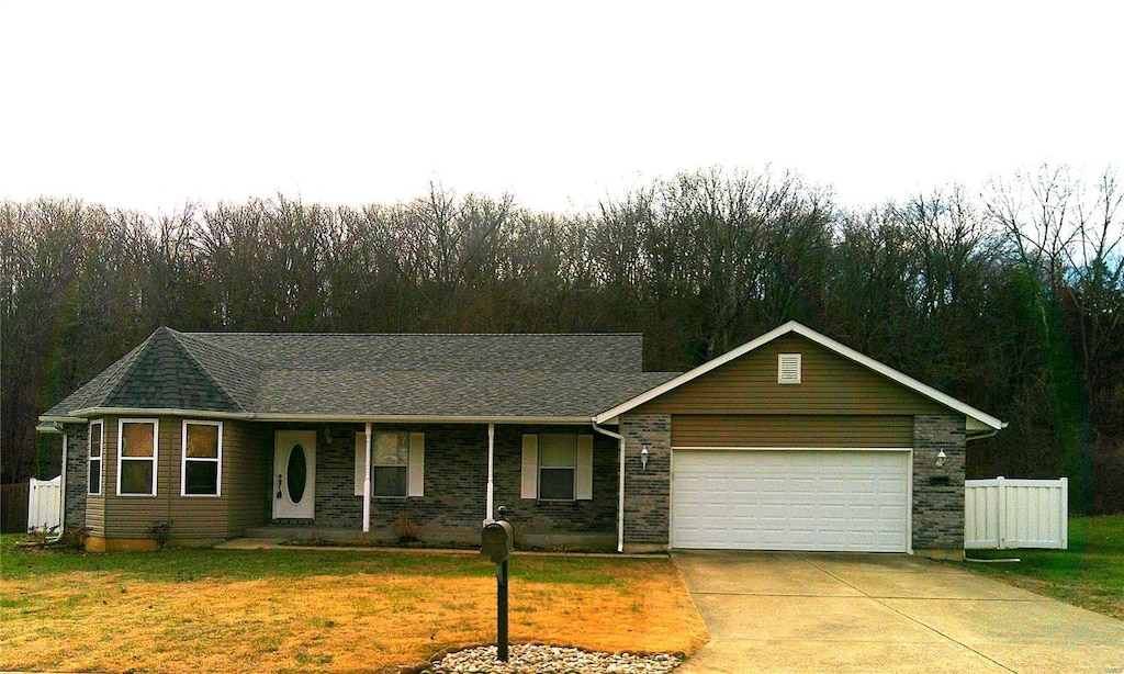 ranch-style home with a garage and a front yard