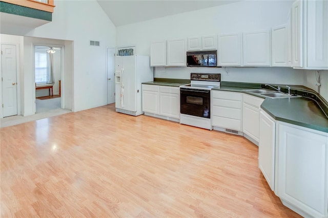 kitchen featuring white appliances, white cabinetry, and sink