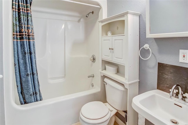 full bathroom featuring shower / bath combination with curtain, toilet, and sink