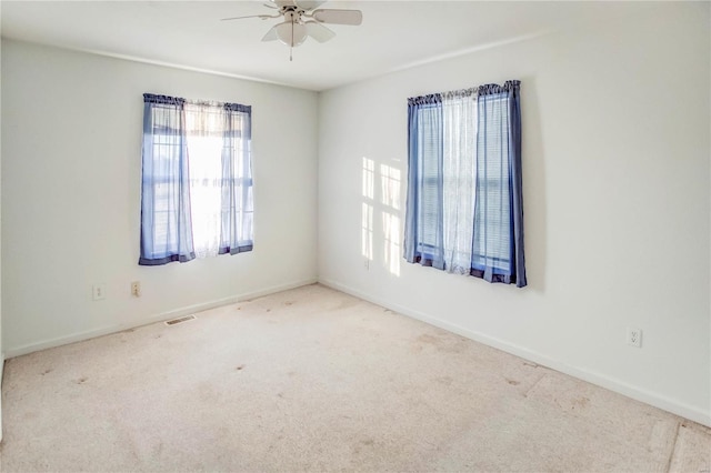 carpeted empty room featuring ceiling fan