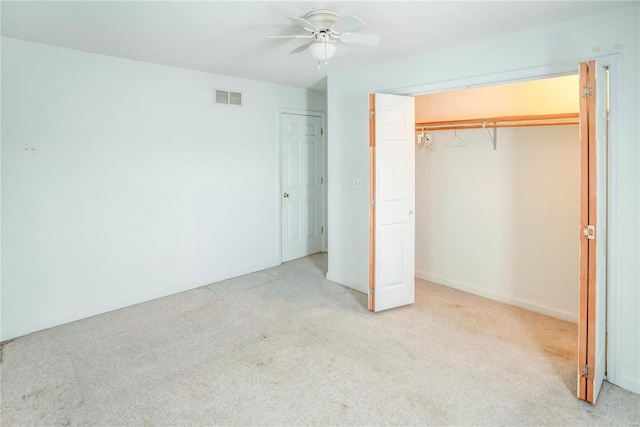 unfurnished bedroom with ceiling fan and light colored carpet