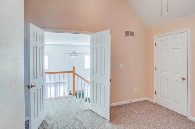 hallway featuring carpet and lofted ceiling