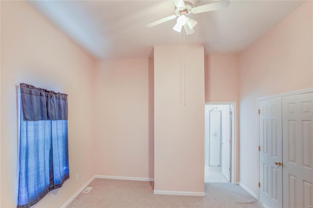 empty room with light carpet and ceiling fan