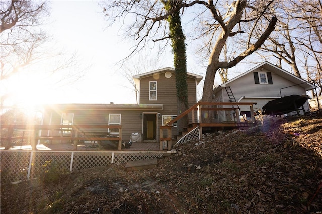 back of house featuring a deck