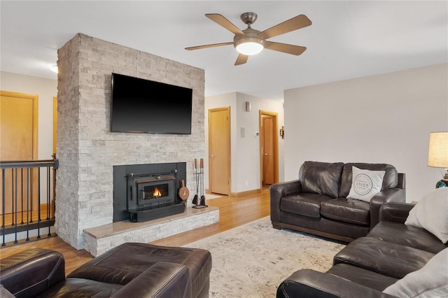 living room featuring ceiling fan and light hardwood / wood-style floors