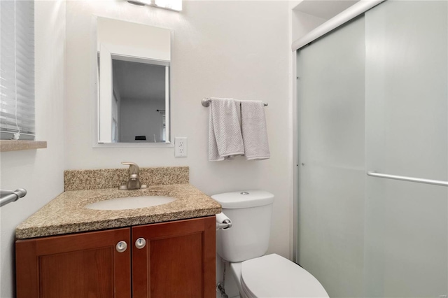 bathroom with vanity, toilet, and walk in shower