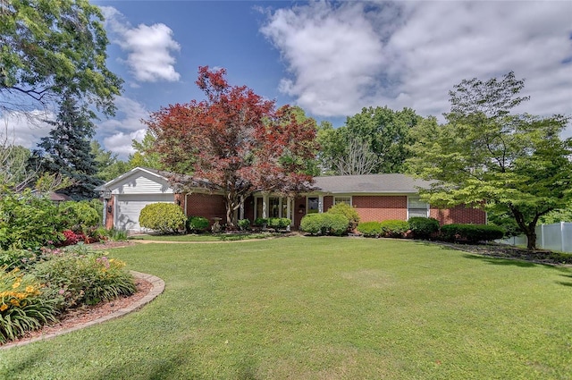 ranch-style home featuring a garage and a front lawn