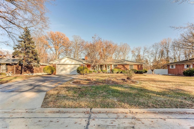 ranch-style house featuring a garage and a front yard